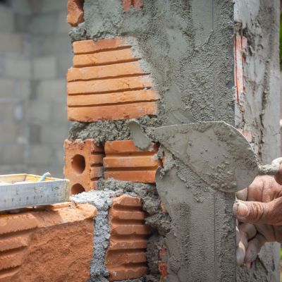 Bricklaying. Construction worker building a brick wall.