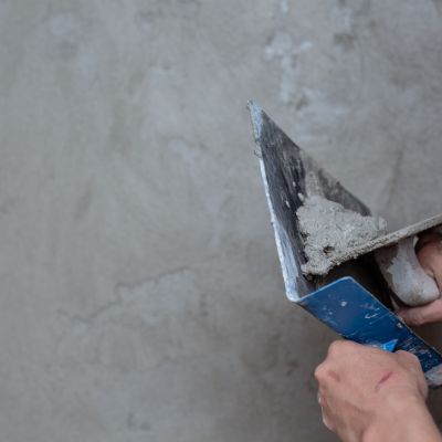 Plasterer renovating indoor walls.